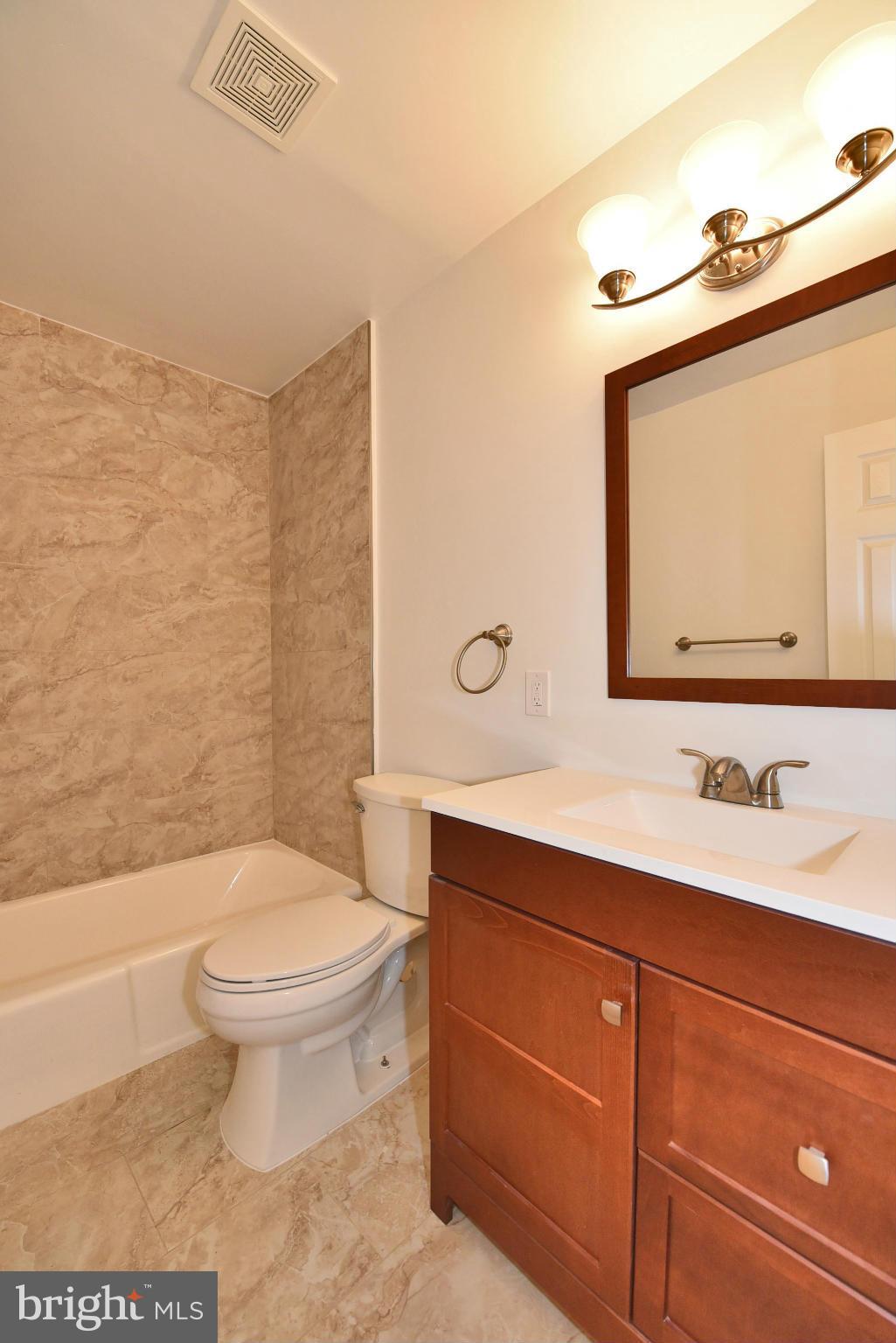 13516 Collingwood Terrace Silver Spring, MD 20904 - Photo 14 of 29 a bathroom with a toilet a sink and mirror
