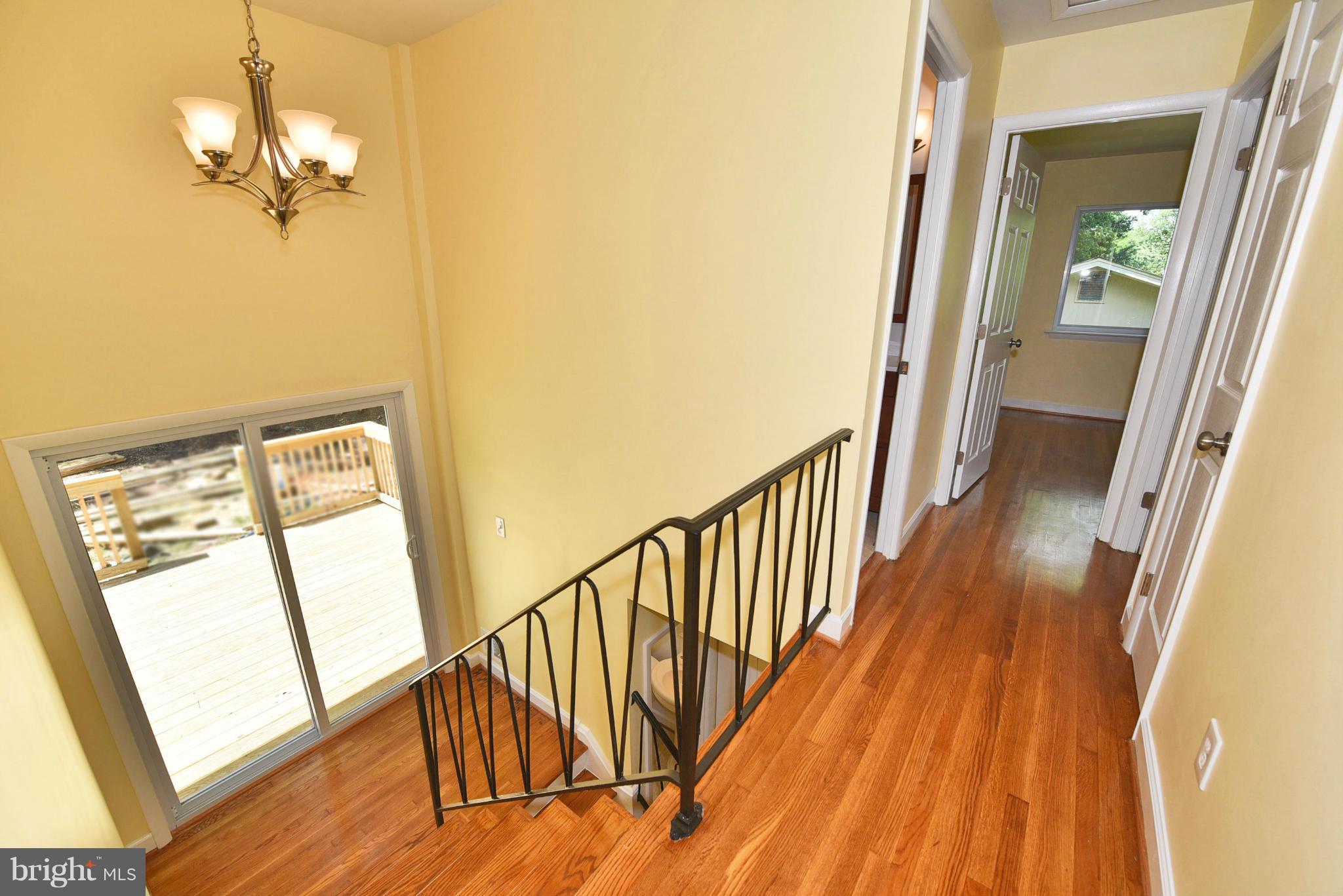 13516 Collingwood Terrace Silver Spring, MD 20904 - Photo 20 of 29 a view of a hallway with wooden floor and stairs