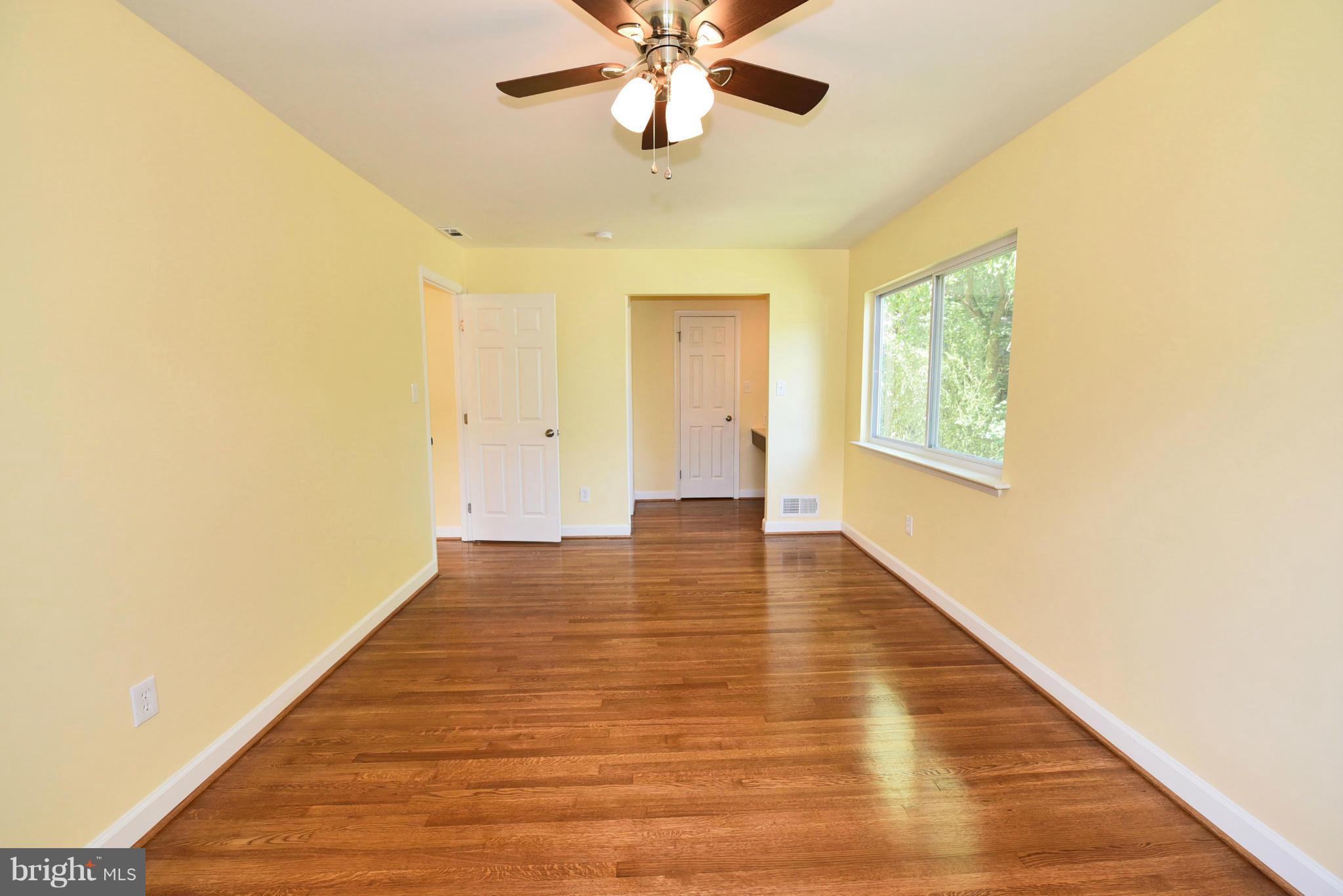 13516 Collingwood Terrace Silver Spring, MD 20904 - Photo 21 of 29 a view of an empty room with wooden floor and a window