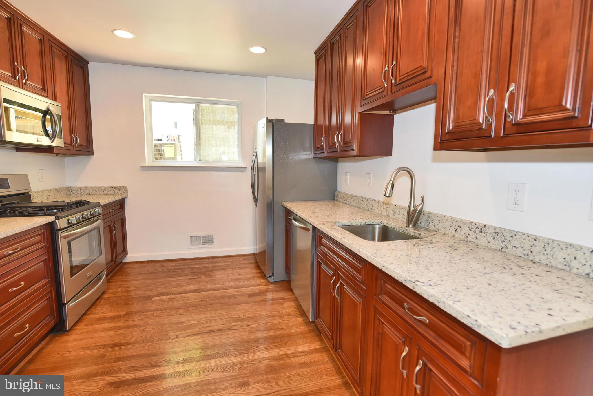 13516 Collingwood Terrace Silver Spring, MD 20904 - Photo 7 of 29 a kitchen with stainless steel appliances granite countertop a sink stove and cabinets