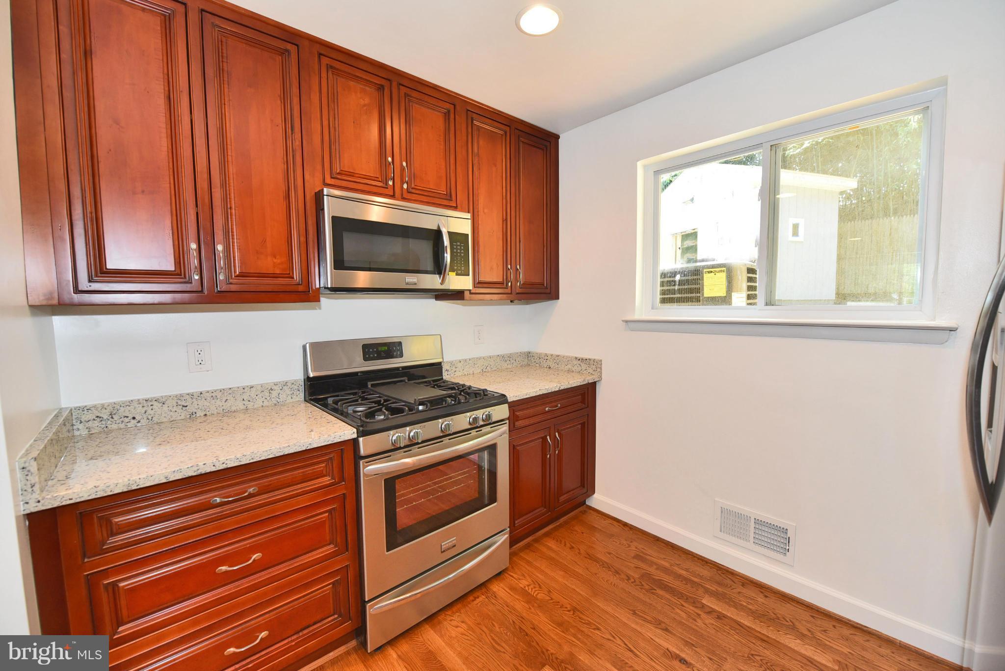 13516 Collingwood Terrace Silver Spring, MD 20904 - Photo 9 of 29 a kitchen with wooden floor and a stove top oven