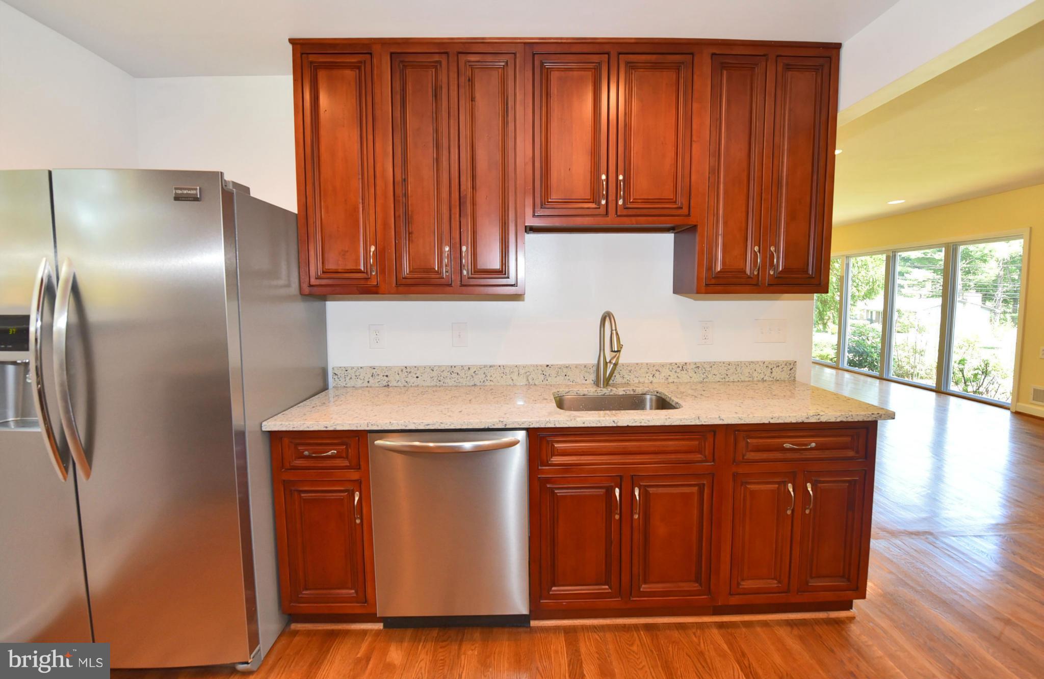 13516 Collingwood Terrace Silver Spring, MD 20904 - Photo 10 of 29 a kitchen with stainless steel appliances granite countertop a sink and a refrigerator