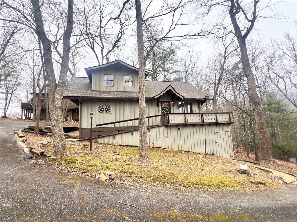 a view of a house with a snow on the road and covered with snow in front of house