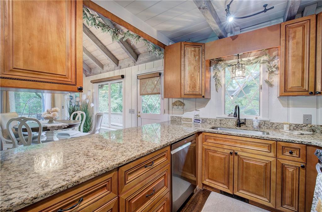 298 Lake View Trace Jasper, GA 30143 - Photo 12 of 33 a kitchen with stainless steel appliances granite countertop a sink a stove and cabinets