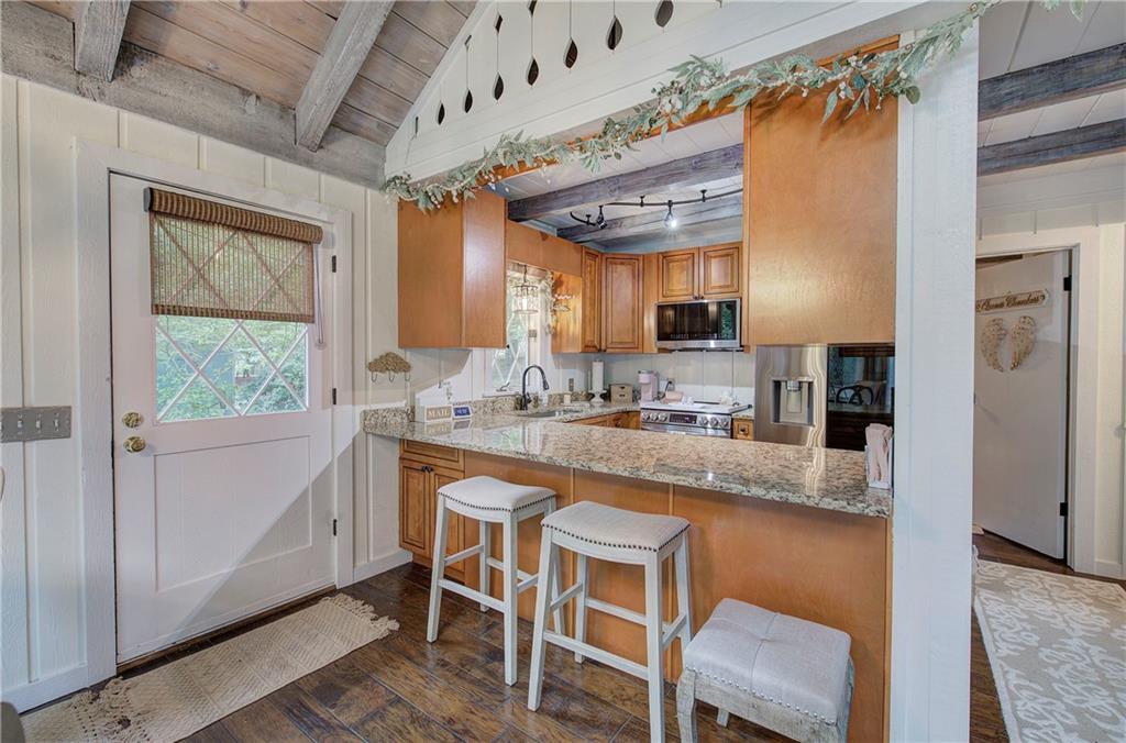 298 Lake View Trace Jasper, GA 30143 - Photo 15 of 31 a kitchen with stainless steel appliances granite countertop a sink and a refrigerator