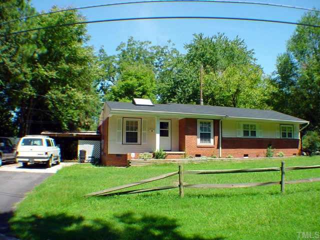 2419 Boswell Road Raleigh, NC 27610 - Photo 1 of 1 a front view of a house with a yard table and chairs