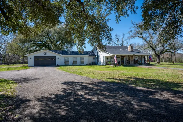 a view of house with a garden