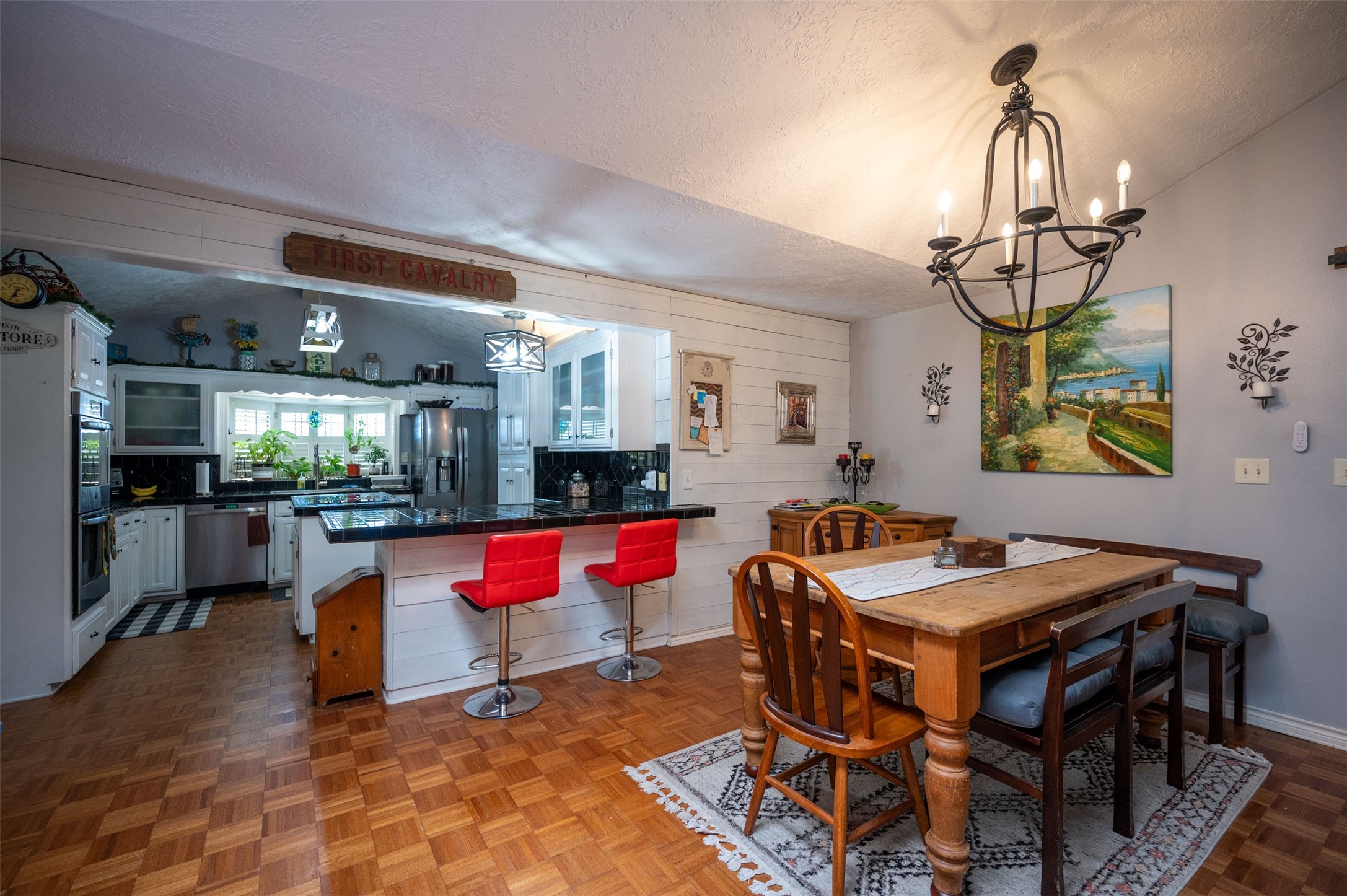 228 Camden Road Chester, TX 75936 - Photo 19 of 50 a dining room with wooden floor a chandelier a wooden table and chairs