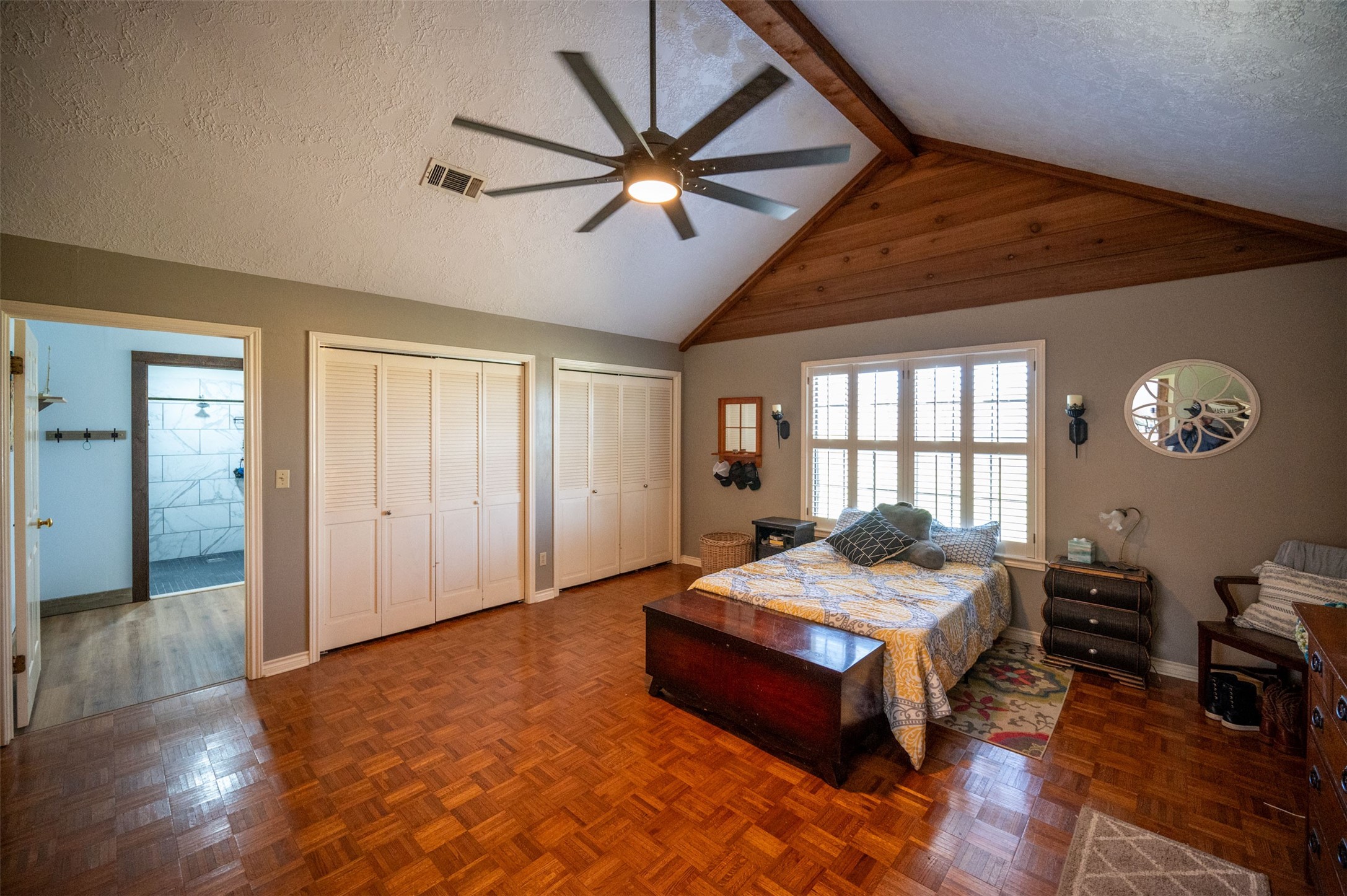 228 Camden Road Chester, TX 75936 - Photo 25 of 50 a spacious bedroom with a bed and a chandelier