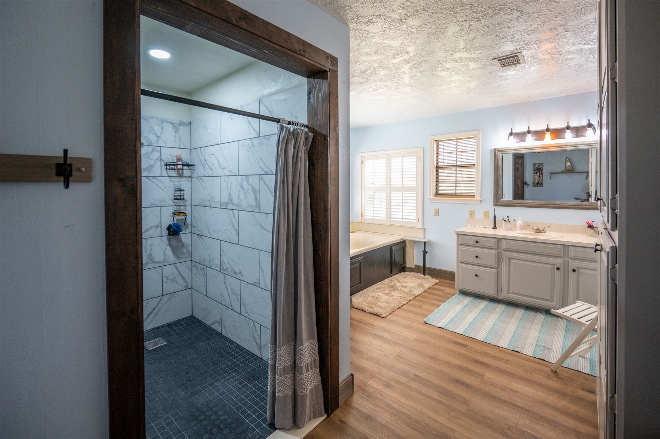 228 Camden Road Chester, TX 75936 - Photo 30 of 50 a bathroom with a sink a mirror and a shower