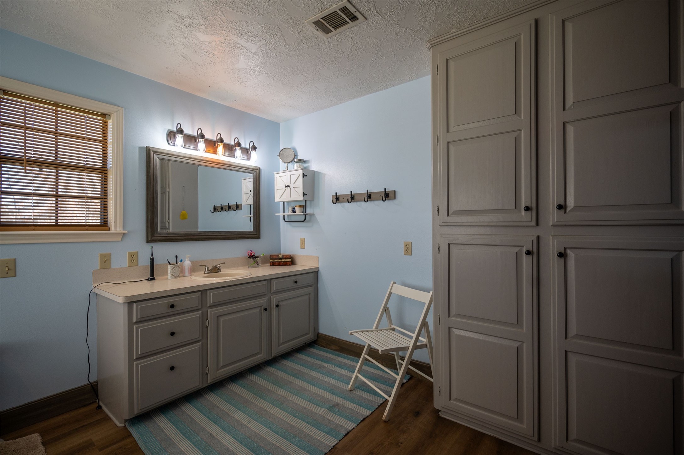 228 Camden Road Chester, TX 75936 - Photo 31 of 50 a bathroom with a double vanity sink and mirror