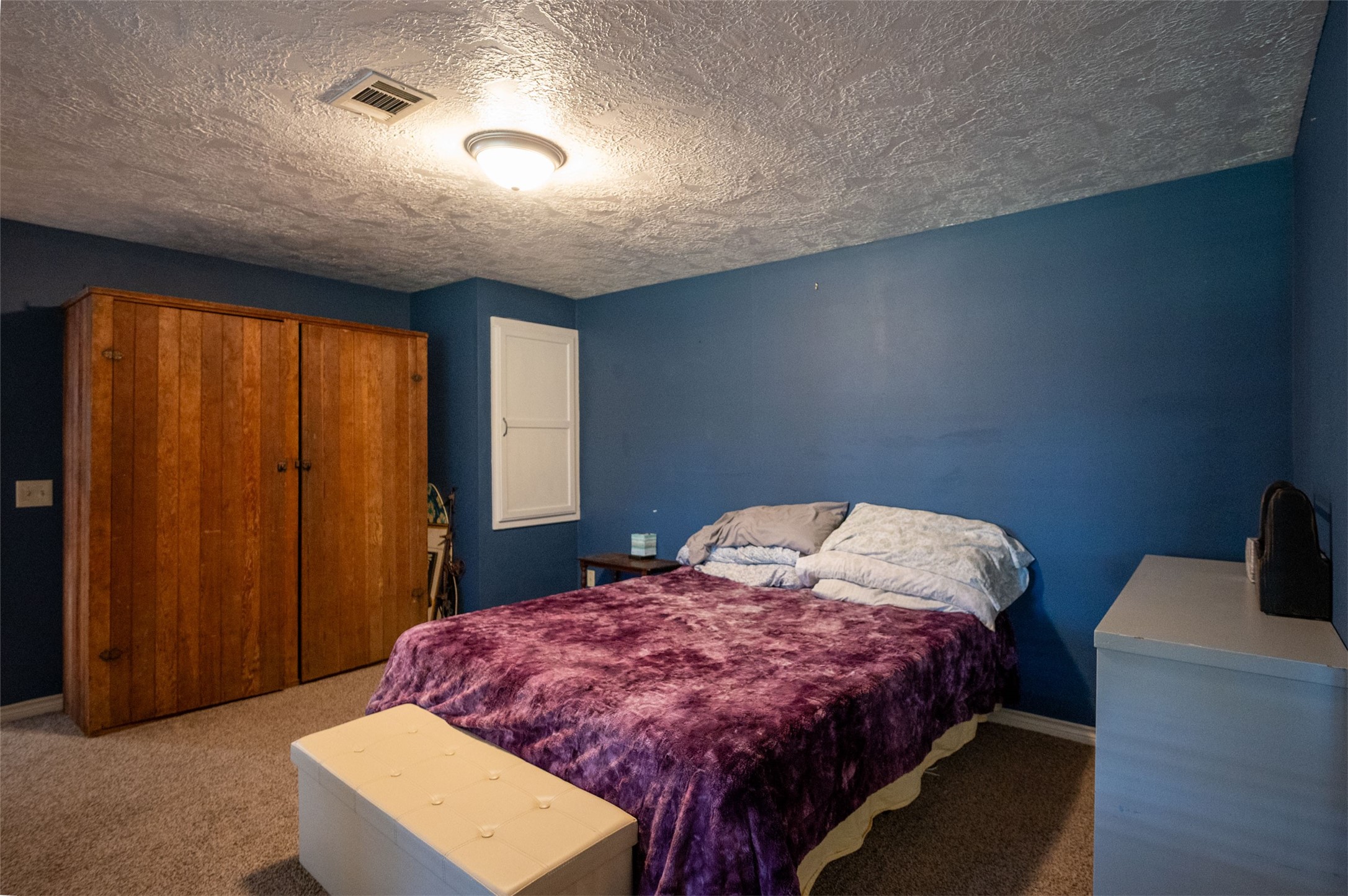 228 Camden Road Chester, TX 75936 - Photo 37 of 50 a bed sitting in a bedroom next to a window