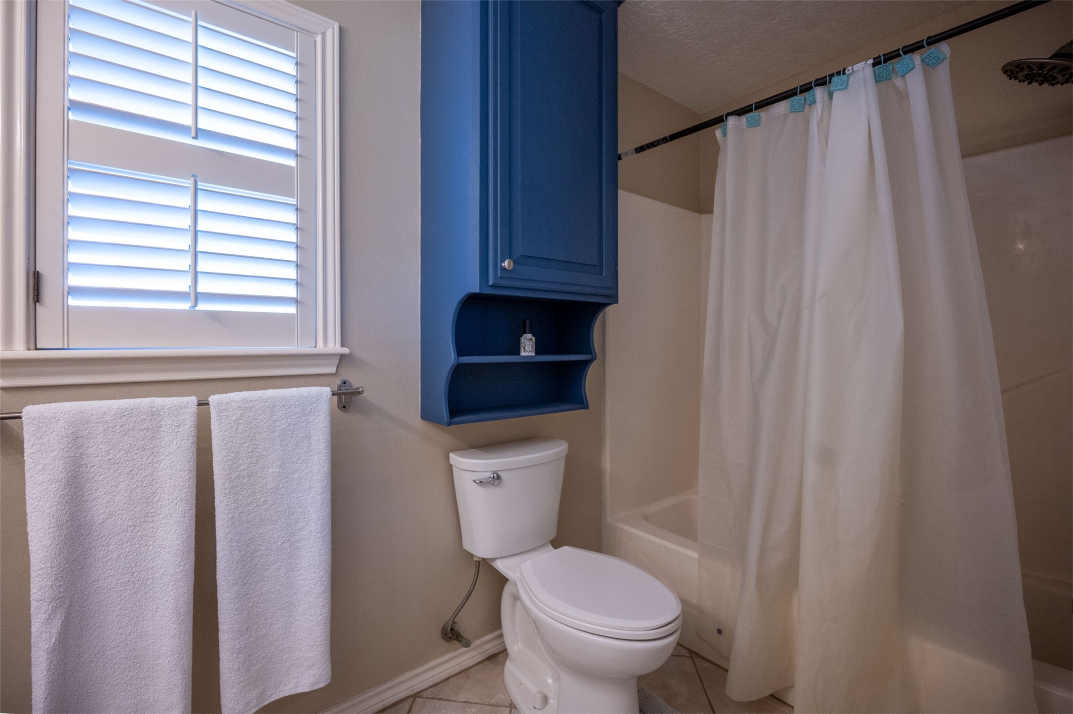 228 Camden Road Chester, TX 75936 - Photo 38 of 50 a white toilet sitting next to a shower curtain