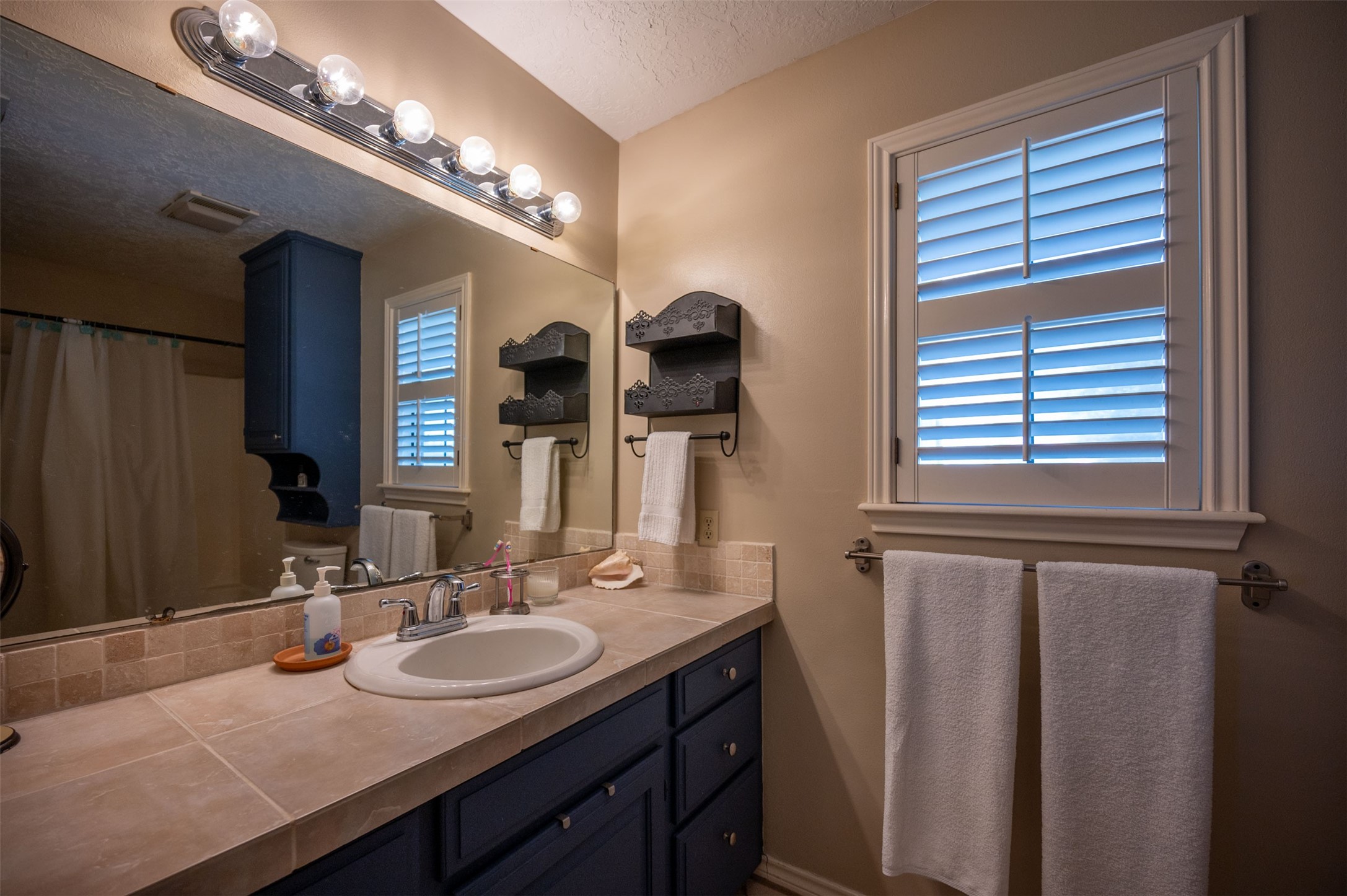228 Camden Road Chester, TX 75936 - Photo 39 of 50 a bathroom with a double vanity sink and a mirror