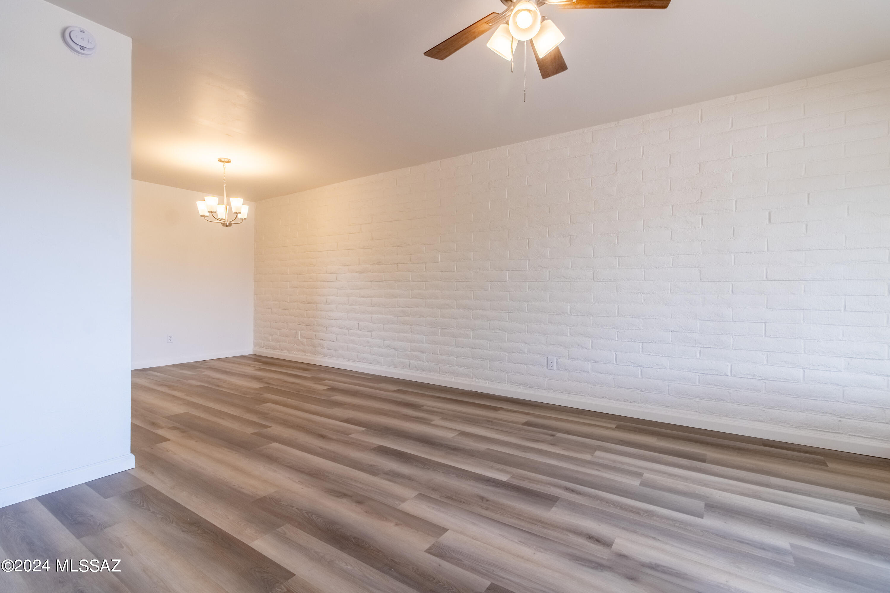 1846 West Dominy Road Tucson, AZ 85713 - Photo 3 of 17 a view of a room with wooden floor and fan