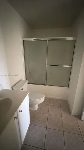 a bathroom with a toilet a sink a vanity and mirror