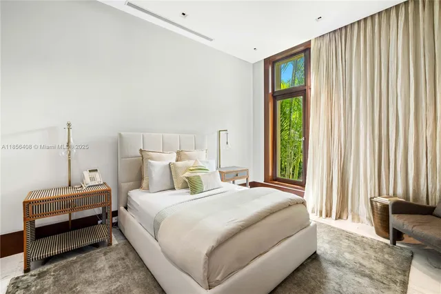 a living room with stainless steel appliances kitchen island furniture and a large window