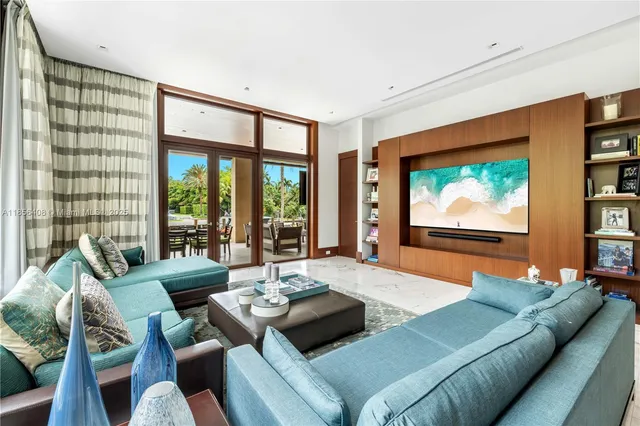 a living room with furniture and a floor to ceiling window