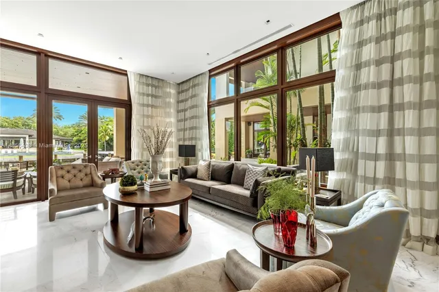 a view of a swimming pool with lawn chairs under an umbrella