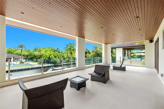 an aerial view of a house with a swimming pool patio and lake view