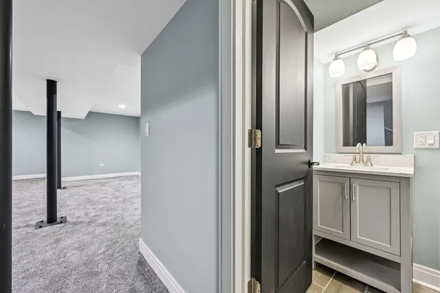 a bathroom with a double vanity sink and a mirror