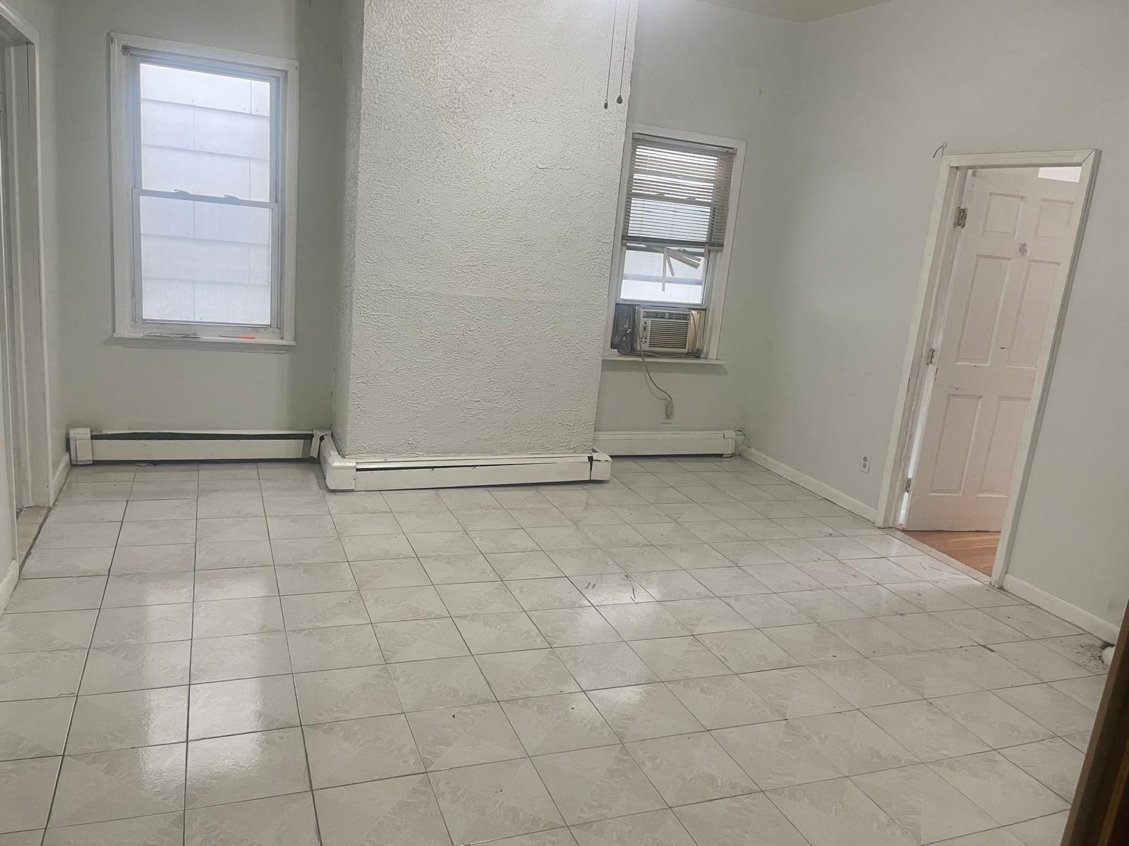 200 Hutton Street, Unit 1 Jersey City, NJ 07307 - Photo 3 of 5 an empty room with windows