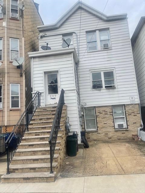 200 Hutton Street, Unit 1 Jersey City, NJ 07307 - Photo 5 of 5 a view of a house with wooden door and two windows