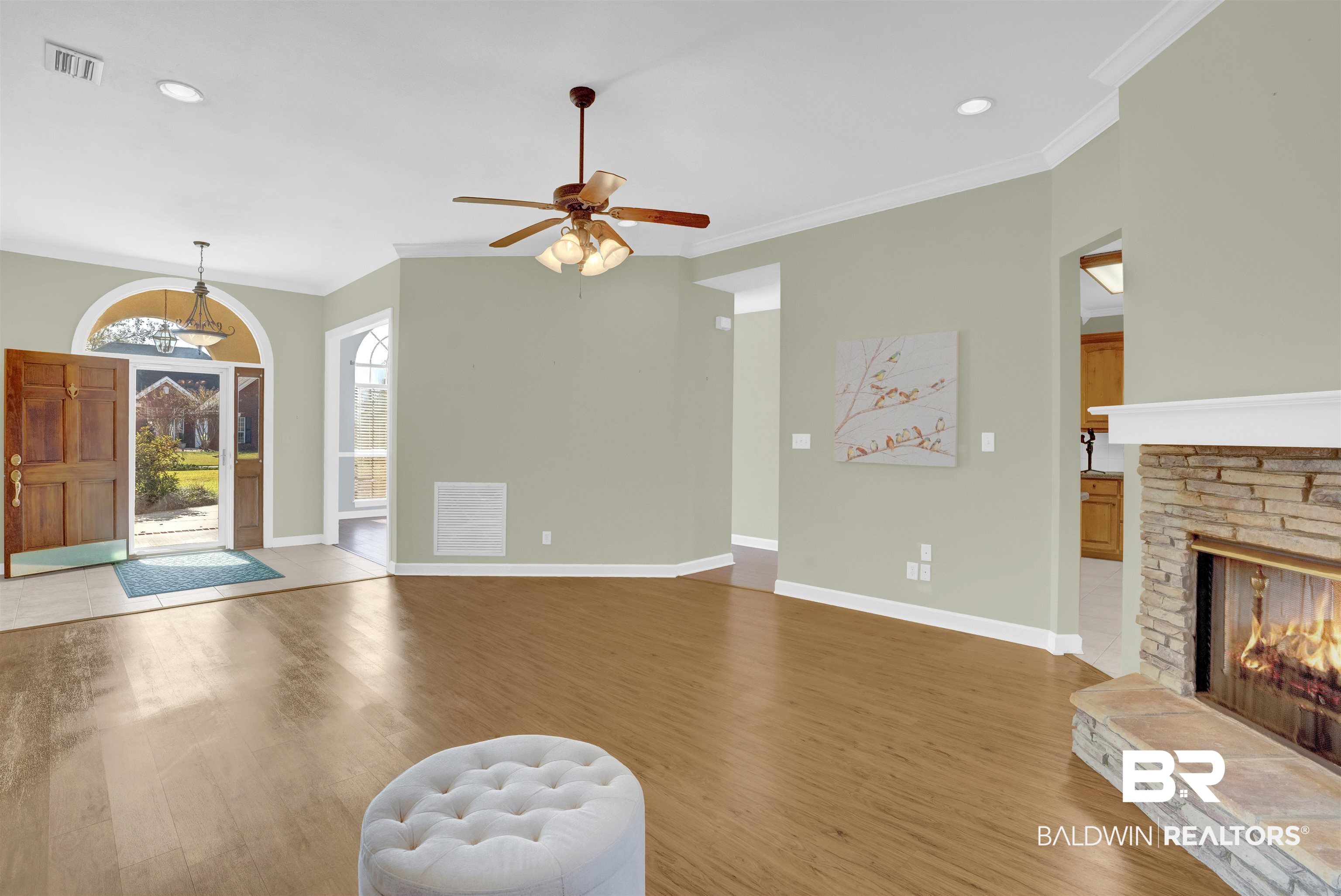 100 Conti Court Fairhope, AL 36532 - Photo 19 of 54 Interior space with ceiling fan, a fireplace, wood-type flooring, and crown molding