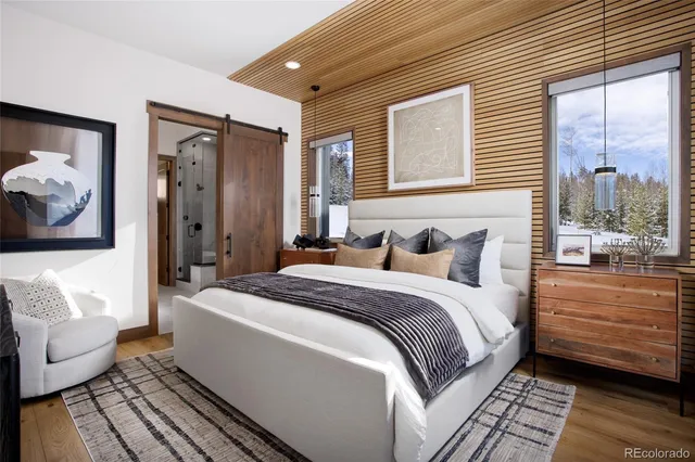 a spacious bedroom with a bed and a couch