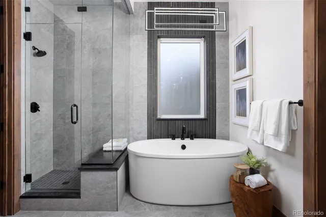 a white bath tub sitting next to a bathroom sink