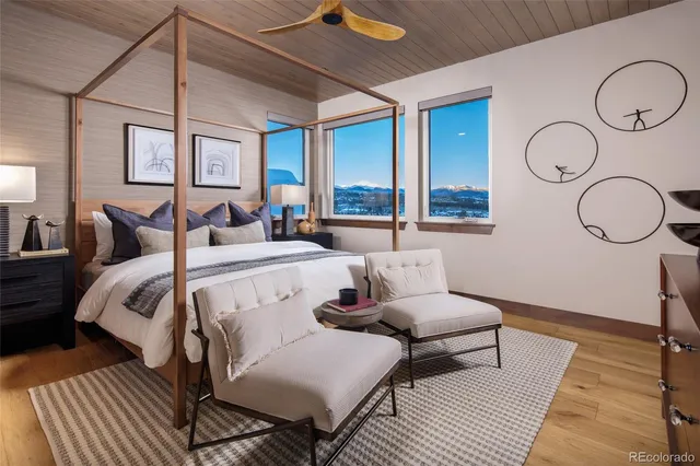 a bedroom with a bed a mirror and a window