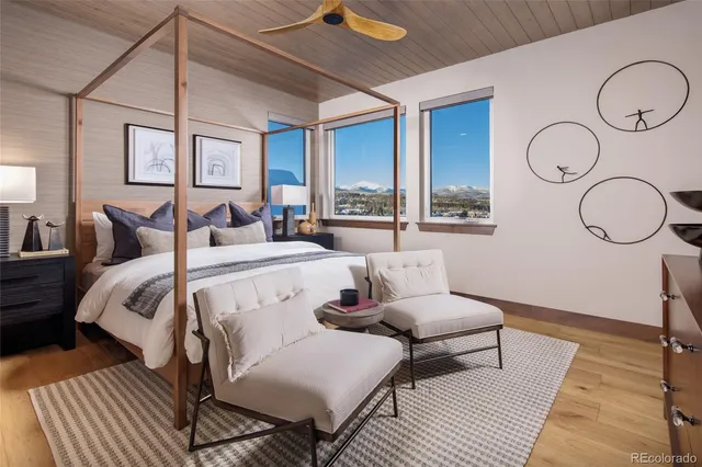 a bedroom with a bed a mirror and a window