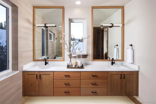 a bathroom with a granite countertop sink and a mirror