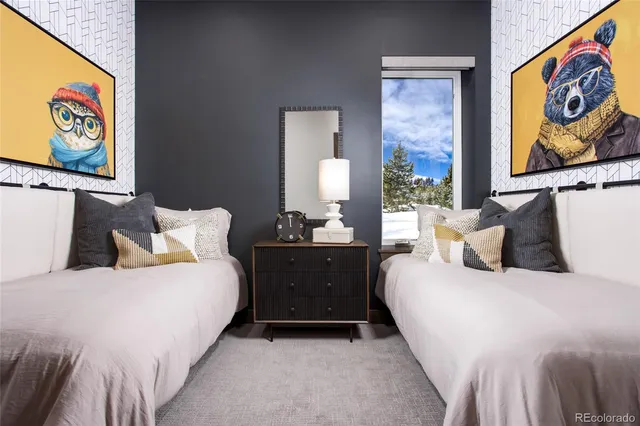 a bedroom with a bed and painting on the wall