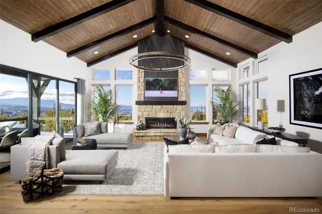 a living room with fireplace furniture and a large window