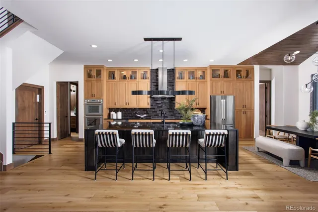 a view of a a dining room with furniture window and wooden floor