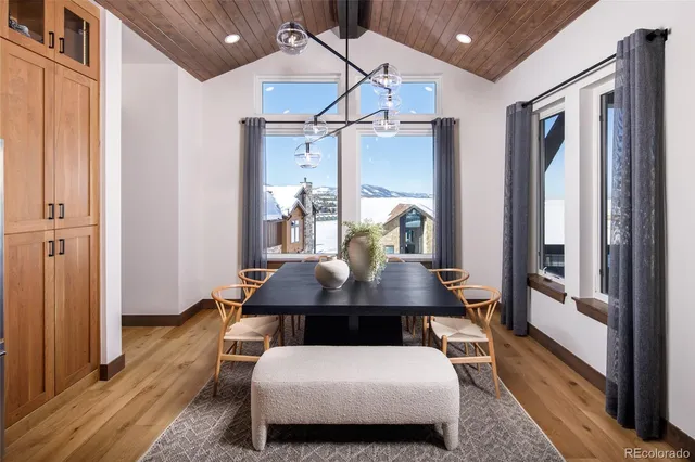 a living room with furniture a flat screen tv and a table