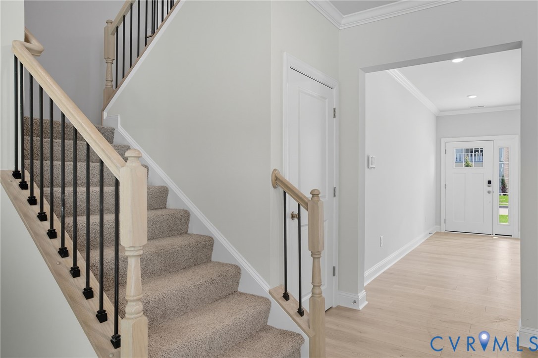 16932 Barmer Road Chesterfield, VA 23832 - Photo 13 of 33 a view of staircase with lots of frames on wall and wooden floor