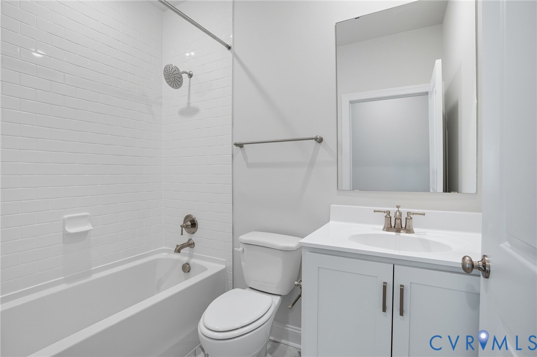 16932 Barmer Road Chesterfield, VA 23832 - Photo 10 of 33 a bathroom with a toilet a sink a mirror a bathtub and vanity