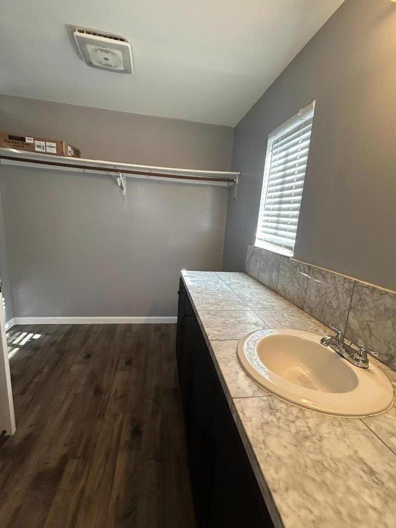 196 Surf Street Pacifica, CA 94044 - Photo 8 of 18 a bathroom with a granite countertop sink and a mirror