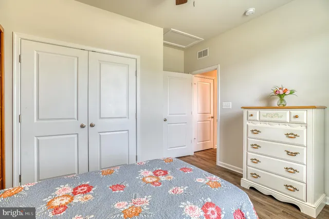 a kitchen with stainless steel appliances granite countertop a sink a stove and a wooden floors