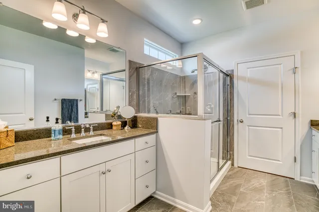 a living room with furniture and two windows