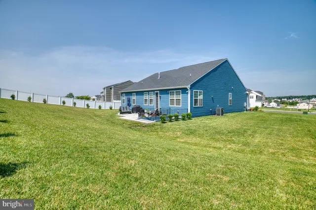 an aerial view of residential houses with outdoor space and swimming pool