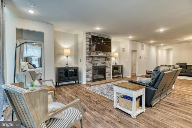 a kitchen with kitchen island granite countertop a sink a center island and cabinets