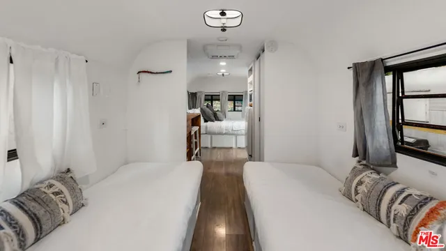 a bedroom with bed and window