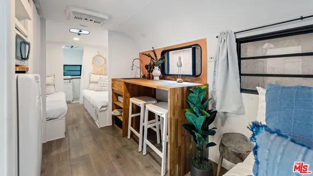 a view of living room kitchen with furniture and wooden floor