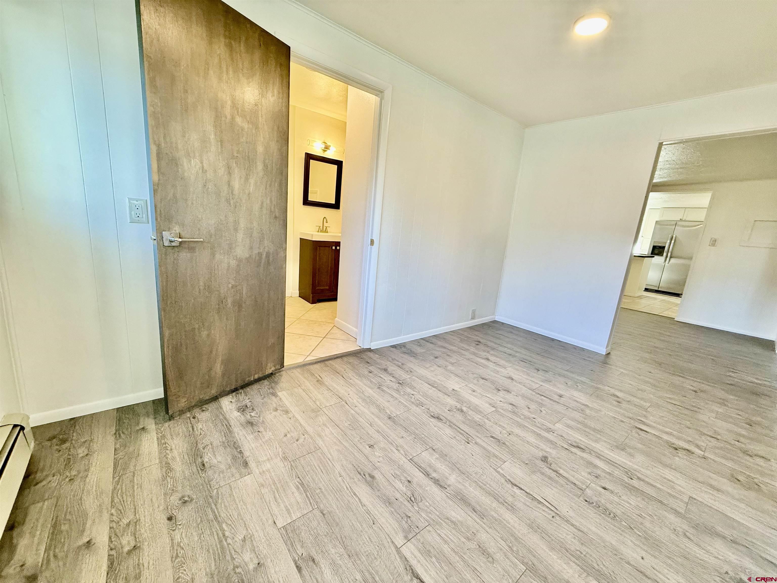 460 Fox Street Nucla, CO 81424 - Photo 12 of 33 an empty room with wooden floor and entrance