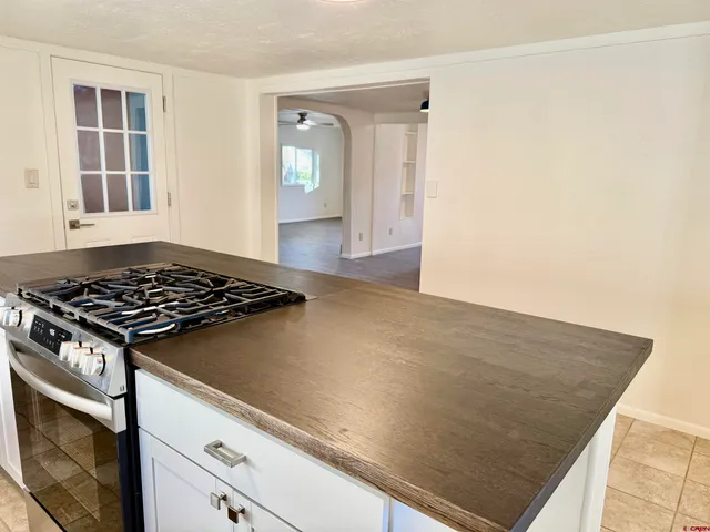 a view of a kitchen with wooden floor and a sink
