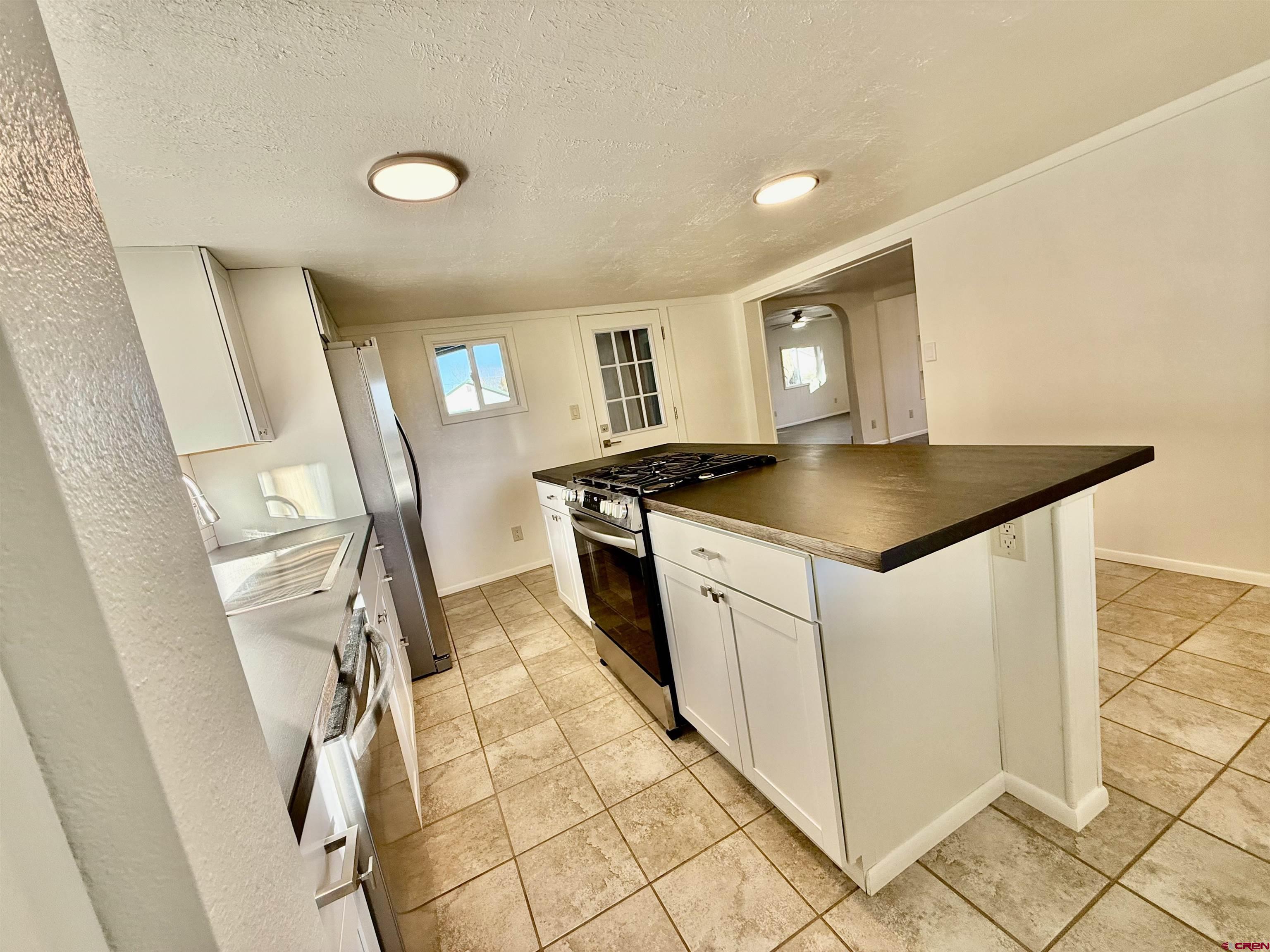 460 Fox Street Nucla, CO 81424 - Photo 15 of 33 a kitchen with a sink a stove top oven and cabinetry