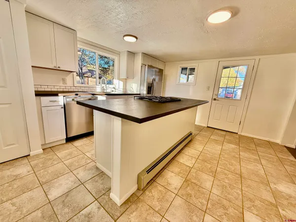 a kitchen with stainless steel appliances granite countertop a sink and cabinets